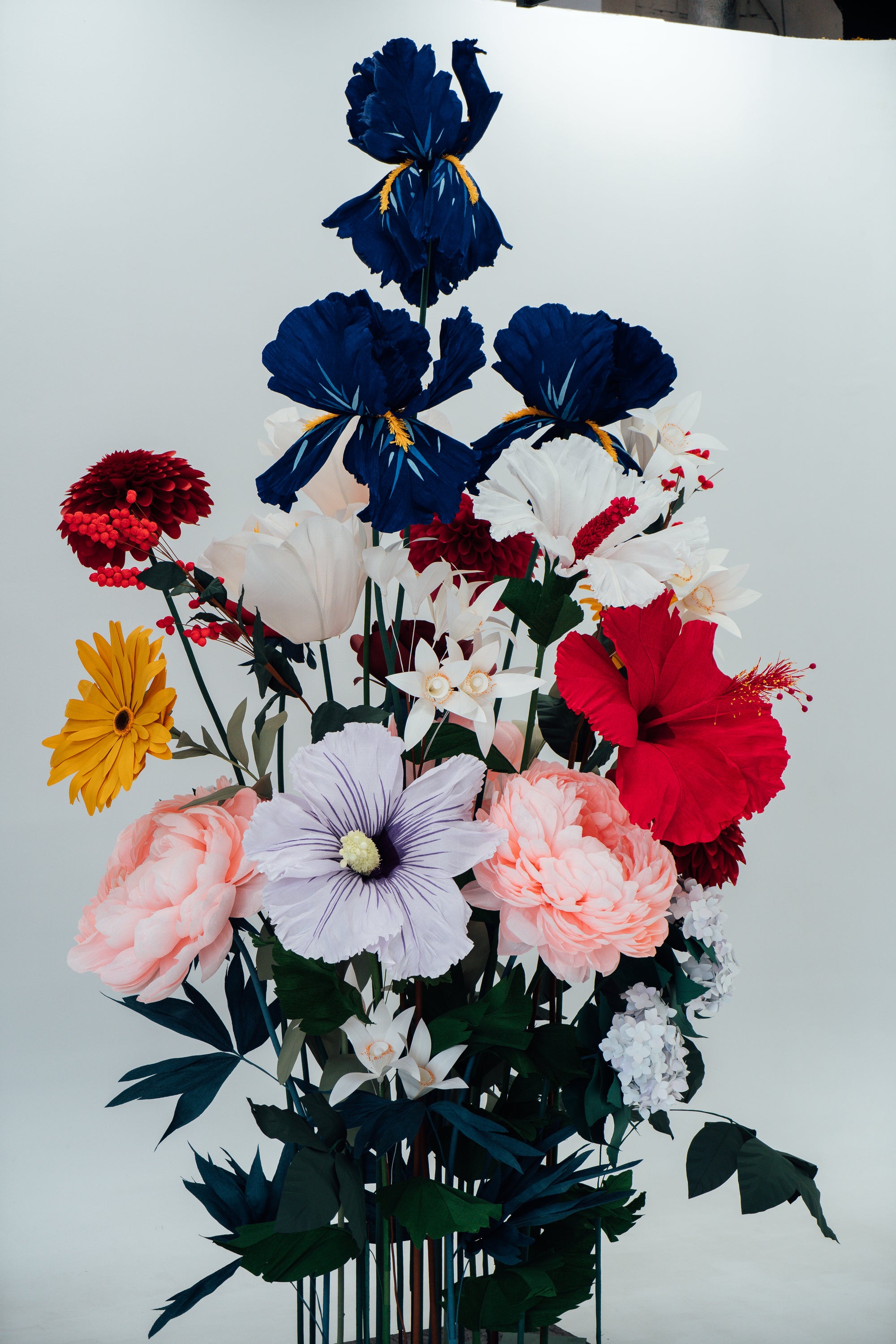 Tangled stems and vibrant blooms in the paper flower installation