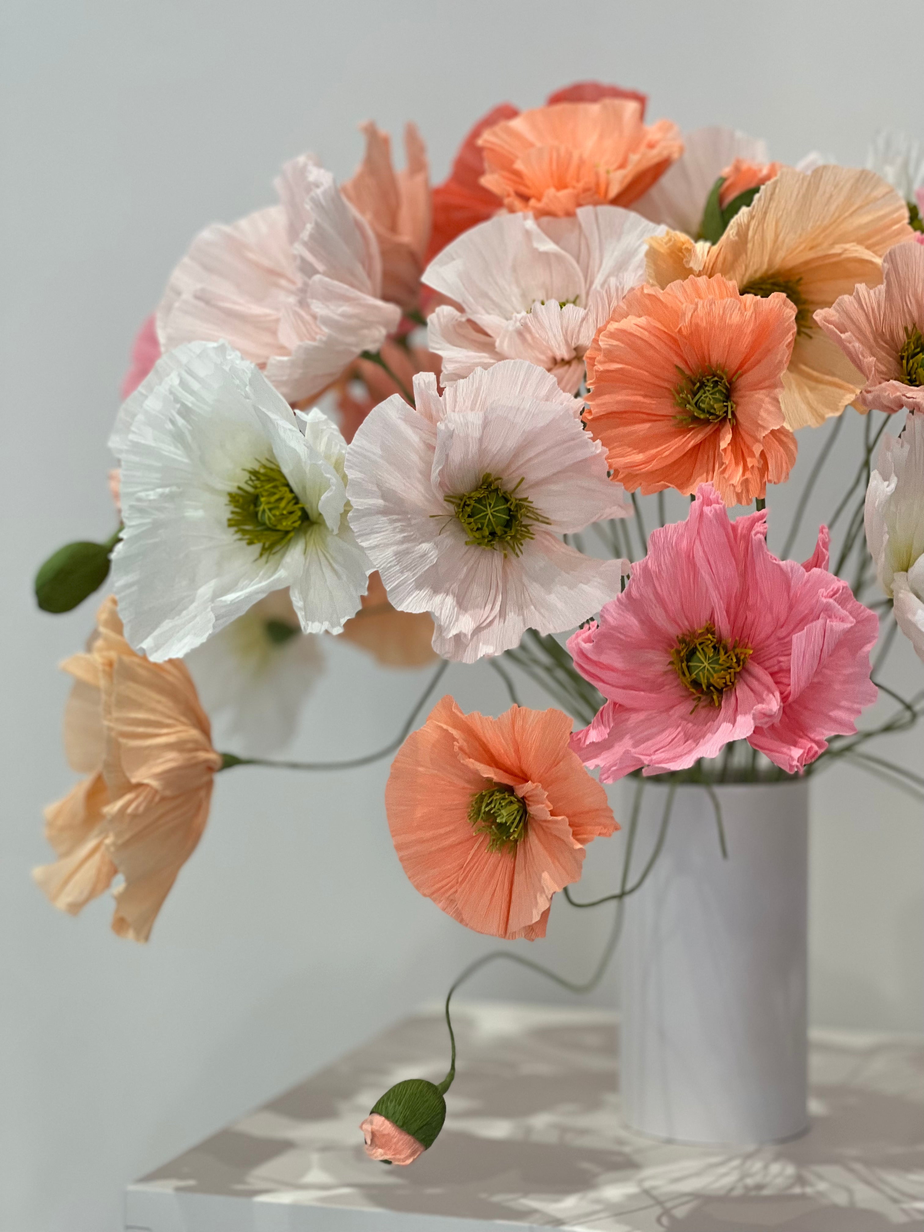 A captivating arrangement of paper poppies, with each bloom displaying intricate details and lifelike textures.