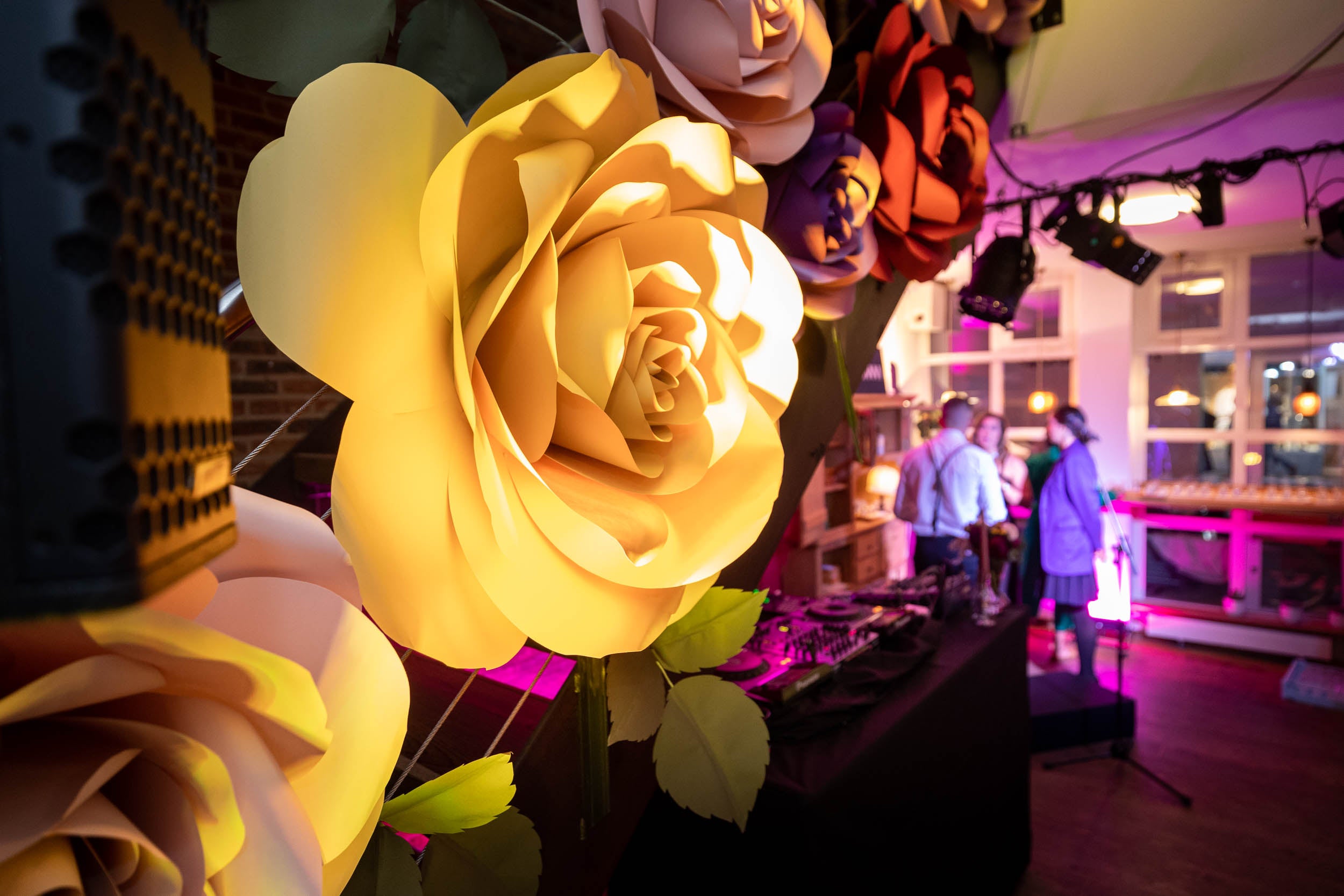 Immersive flower arch installation in ochre and wine tones at Qualcomm House during World Economic Forum in Davos 2022