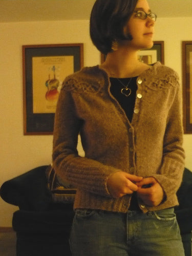 mary wears a hand knit wool cardigan 