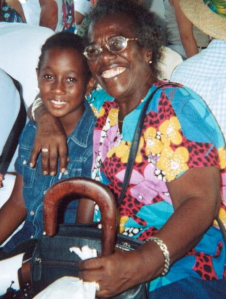 A young Teju with her Grandmother who has her arm lovingly draped over her shoulder.