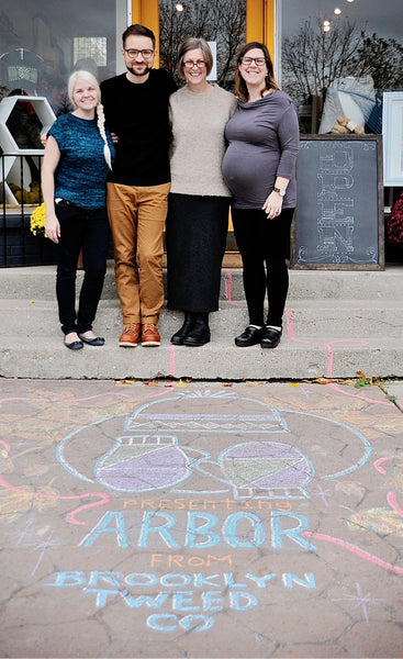 Wool and Honey owners Liz Neddo and Melissa Kelenske stand with Jared Flood outside their shop celebrating the launch of Arbor wool yarn