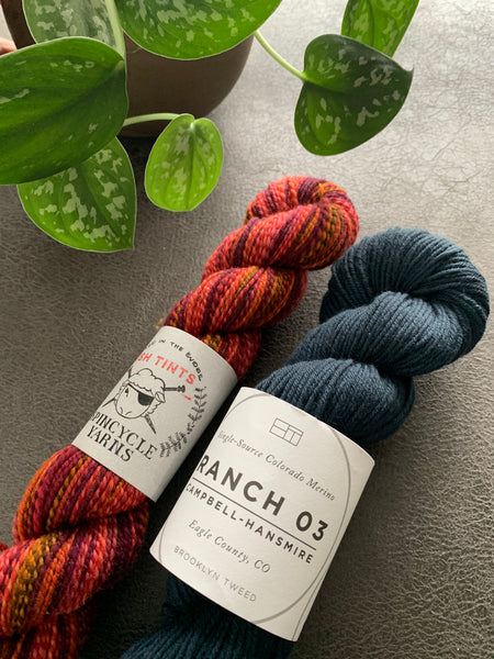 Two skeins of American wool hand knitting yarn from Brooklyn Tweed and Spincycle Yarns
