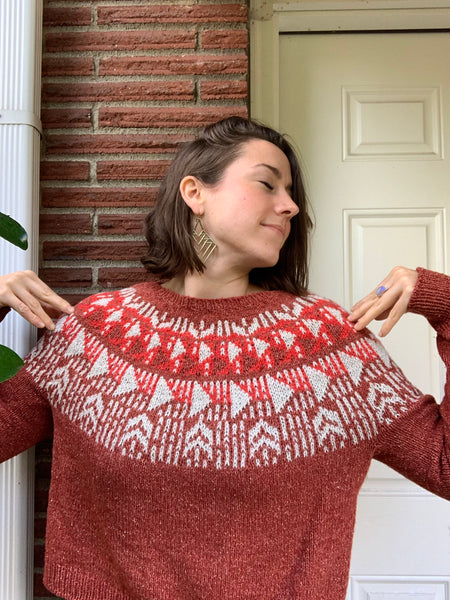 white woman revels in wearing a hand knit sweater pattern made from American organic cotton + merino wool