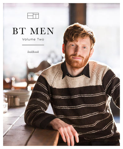 A man sits with his arm resting on a wooden table modeling a hand knit wool striped colorwork pullover. Title reads "BT Men Volume II Lookbook"