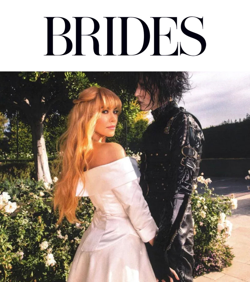 Kourtney Kardashian in white off the shoulder two piece skirt suit and Travis Barker dressed as Edward Scissorhands for Halloween