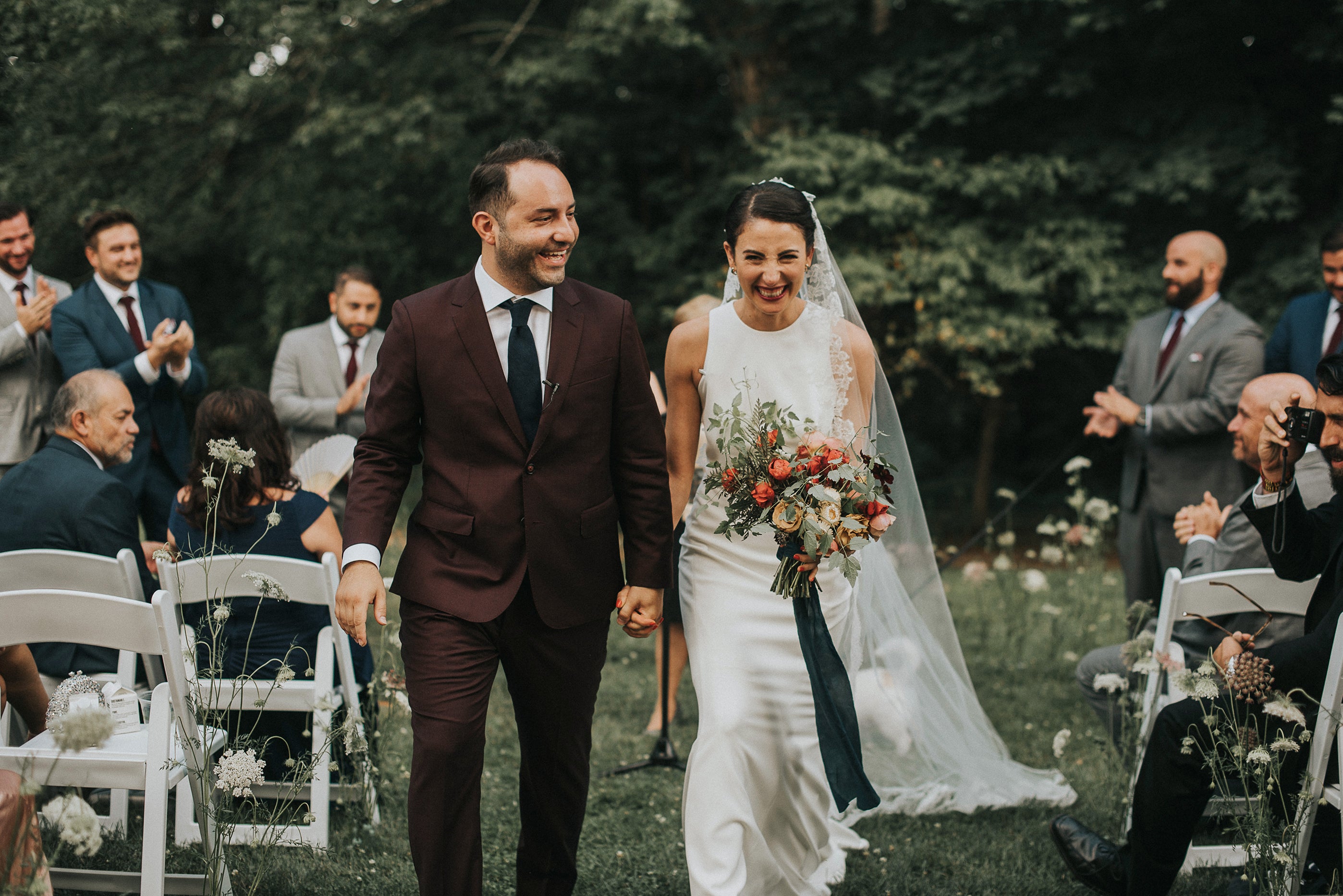 Bride and groom walking down the aisle at garden wedding