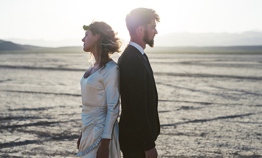 A Wedding Photo at the Dry Lake Bed in Las Vegas, couple is standing back to back