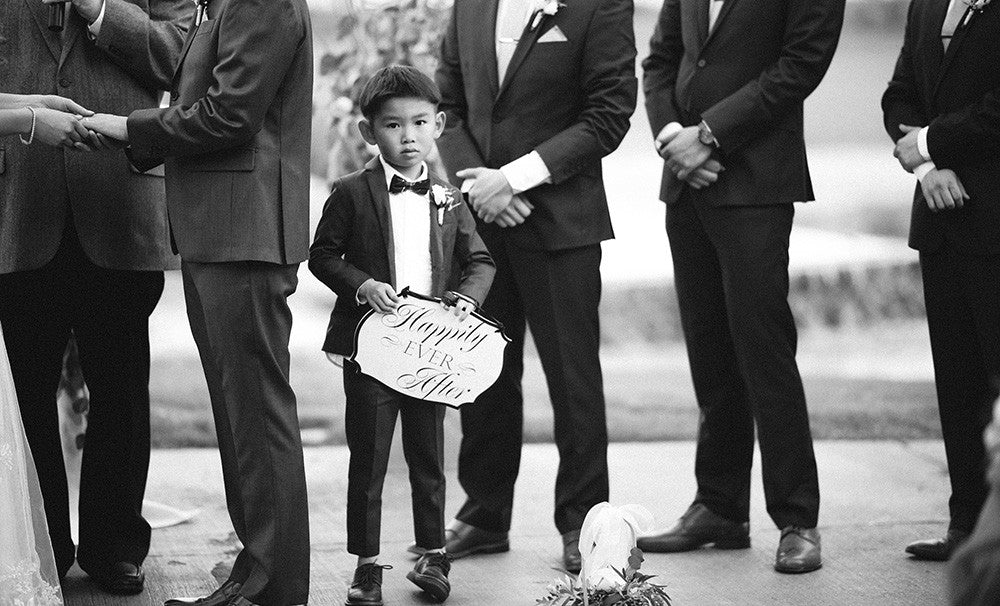 A Ring Bearer with a sign at a Spanish Trails Wedding in Las Vegas