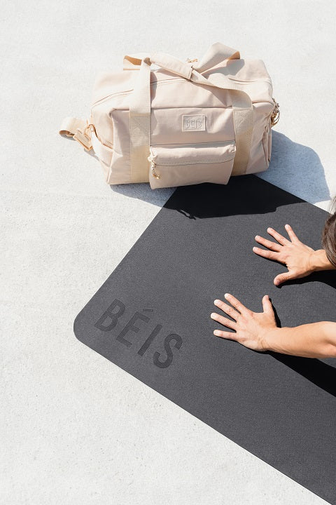 beis sports bag on a yoga mat