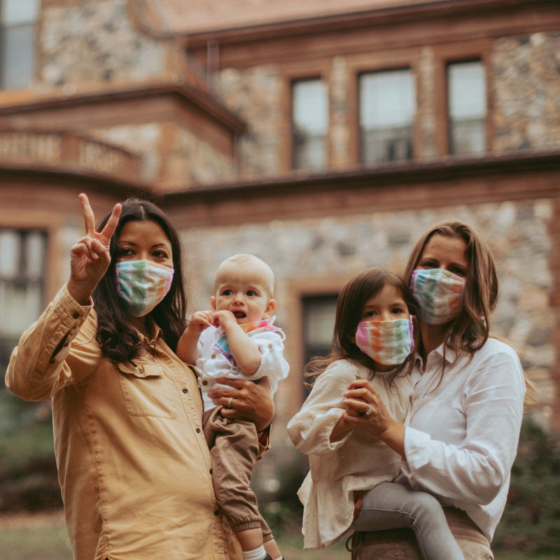 Two moms in pride month with their family