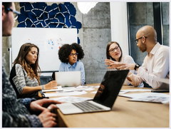 A group of people having a discussion at a conference table