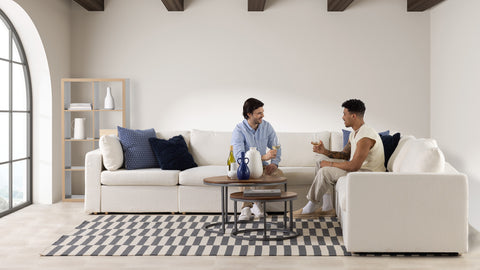 Two people sitting on a light colored couch