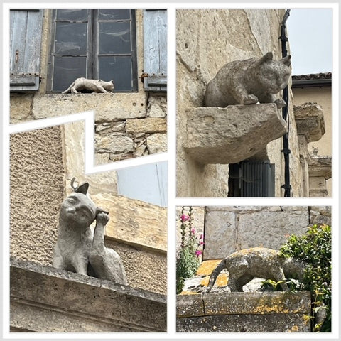 Four of the original stone cats at La Romieu