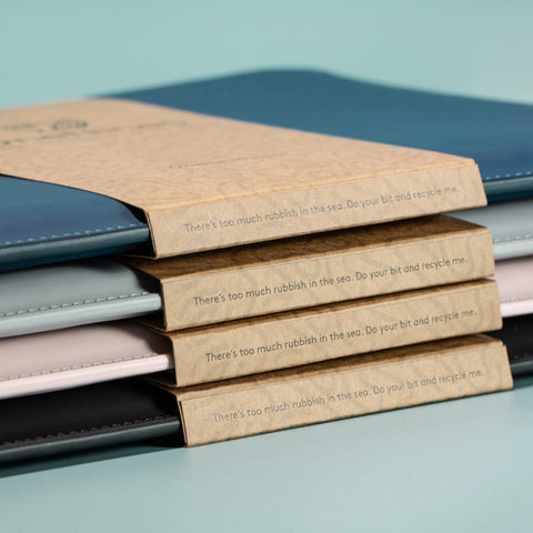 Stacked laptop sleeves showing recyclable feature on sleeve