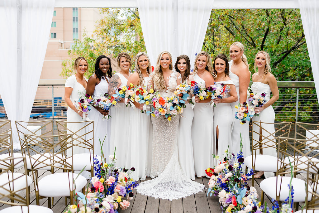 bridesmaids in white dresses, colorful bridesmaid bouquet, arrangement with red anthurium