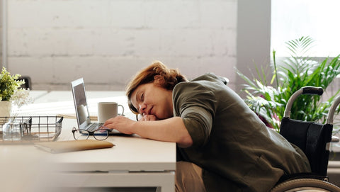 Tired corporate woman sleeping at her desk