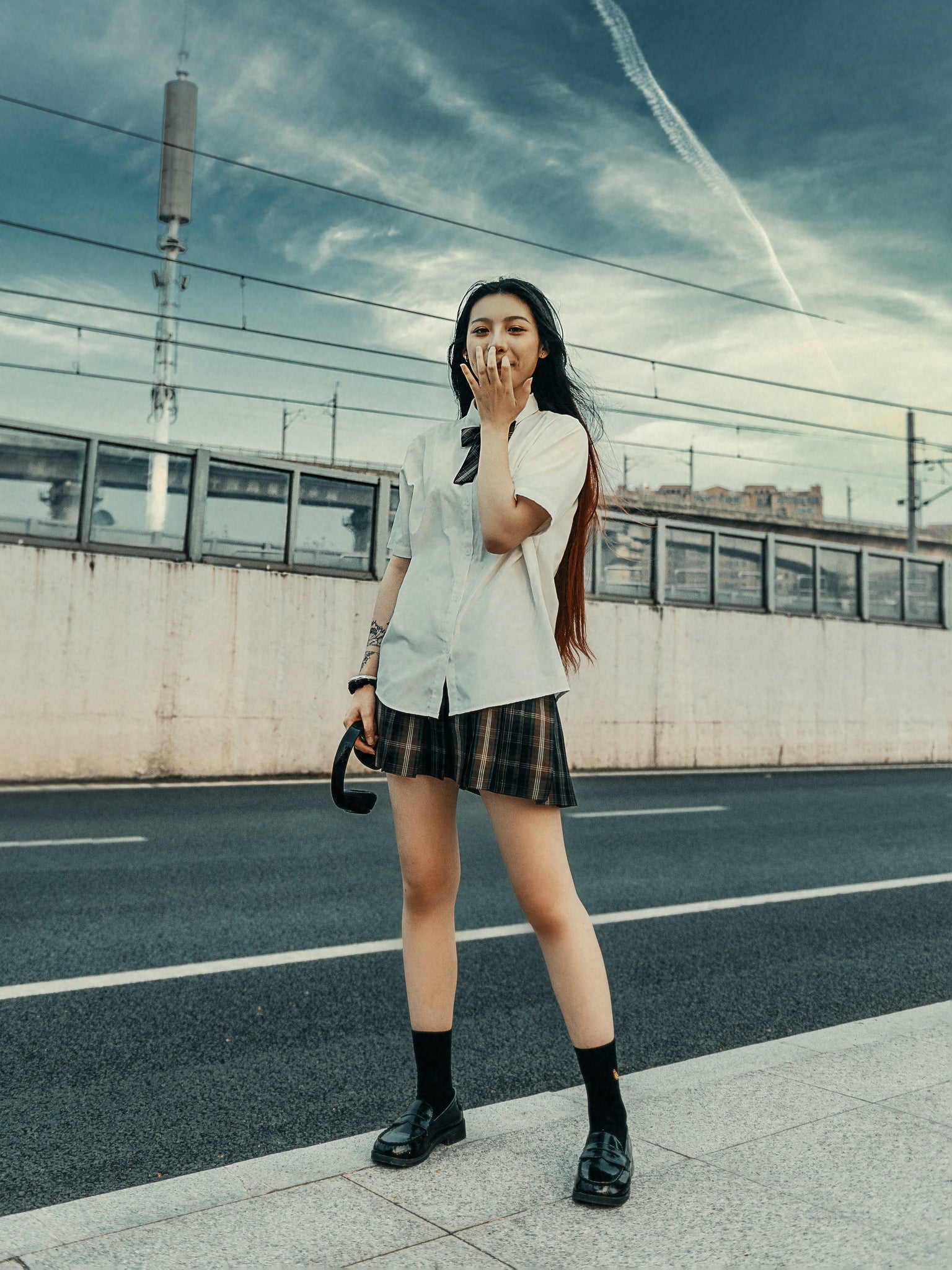 Girl in uniform with pleated skirt