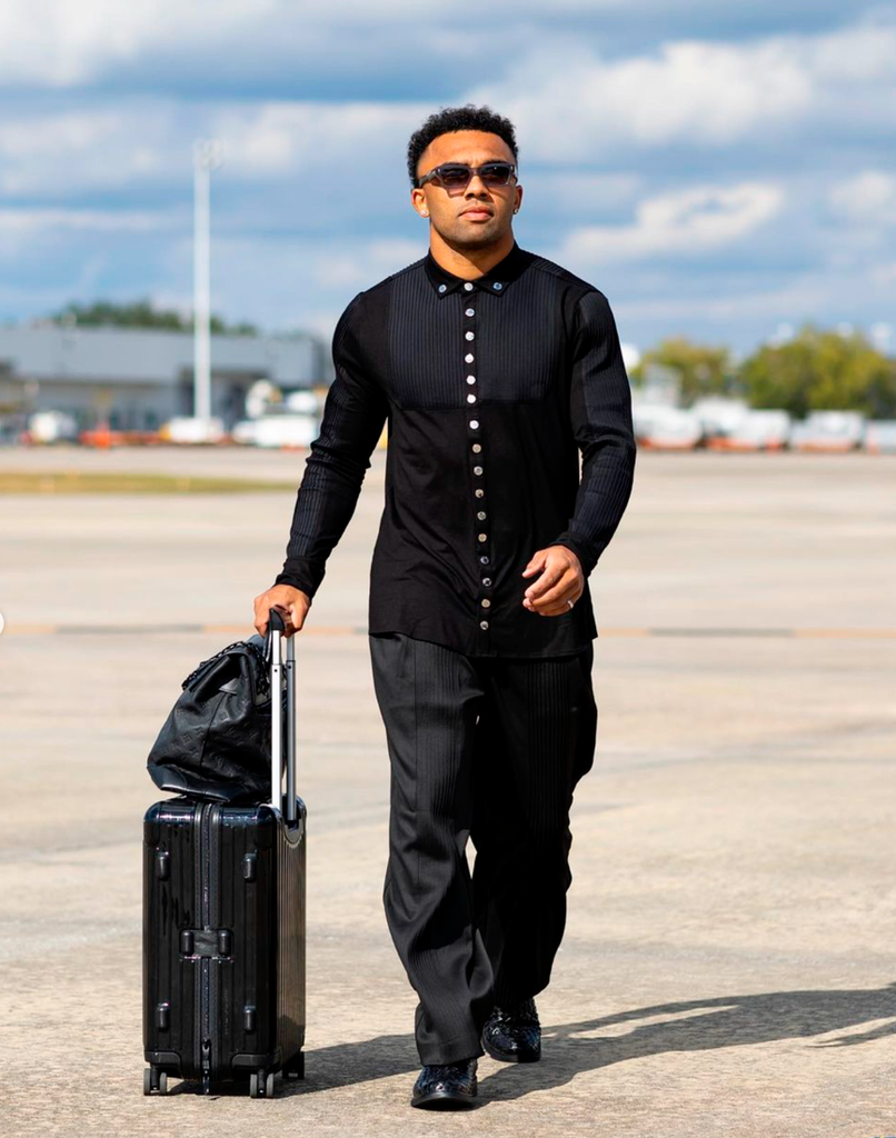 Christian Kirk arrives at airport wearing ORTTU