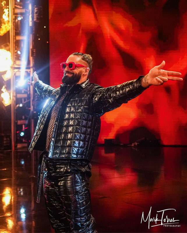 WWE wrestler Seth Rollins wears shiny black Shelton Puffer Jacket and Shelton Puffer Pants by ORTTU
