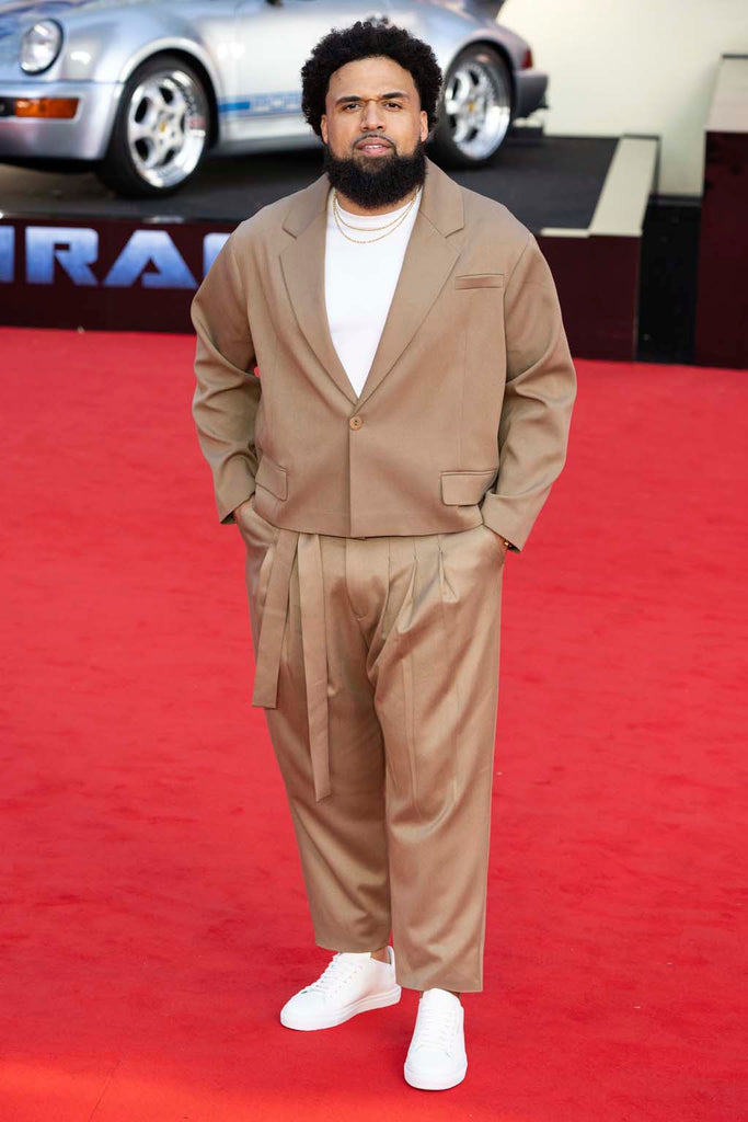 Steven Caple Jr. wearing ORTTU Naoki Jacket and Pants at Transformers NYC premiere