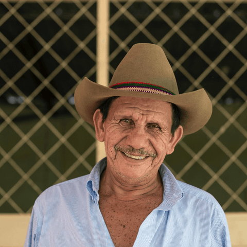 Farmer smiling in a cool hat