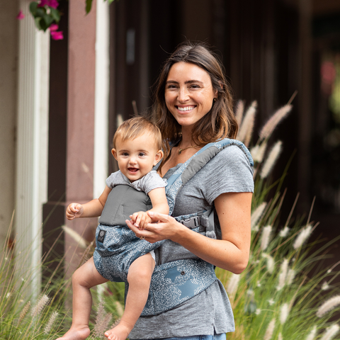 When can babies face forward in a carrier? Mom wearing baby in a carrier