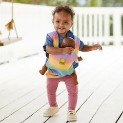 Child wearing a doll in a baby doll carrier