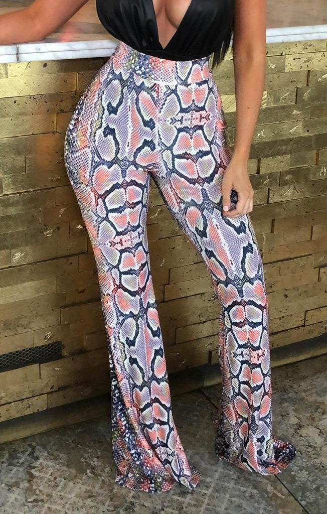 Orange Snake Print Slinky Flare Leg Trousers | Trousers | Femme Luxe UK