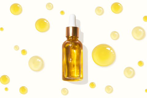 bottle of body oil, with oil droplets