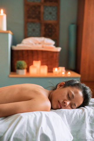 A woman laying on a massage table