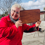 Woman with her finished wooden chopping board
