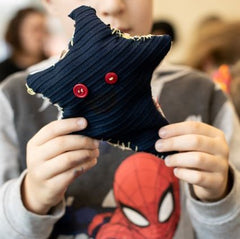 Child holding a navy star with red eyes