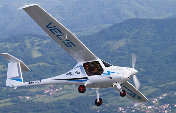 Pipistrel Velis electric 2-seater plane banking in flight