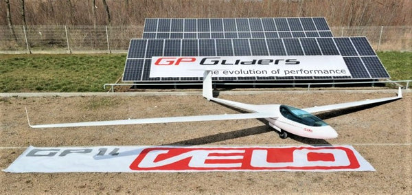 VELO glider on display in front of solar panel