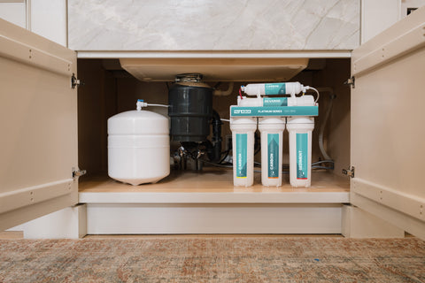 a tanked NU Aqua reverse osmosis system under the kitchen sink