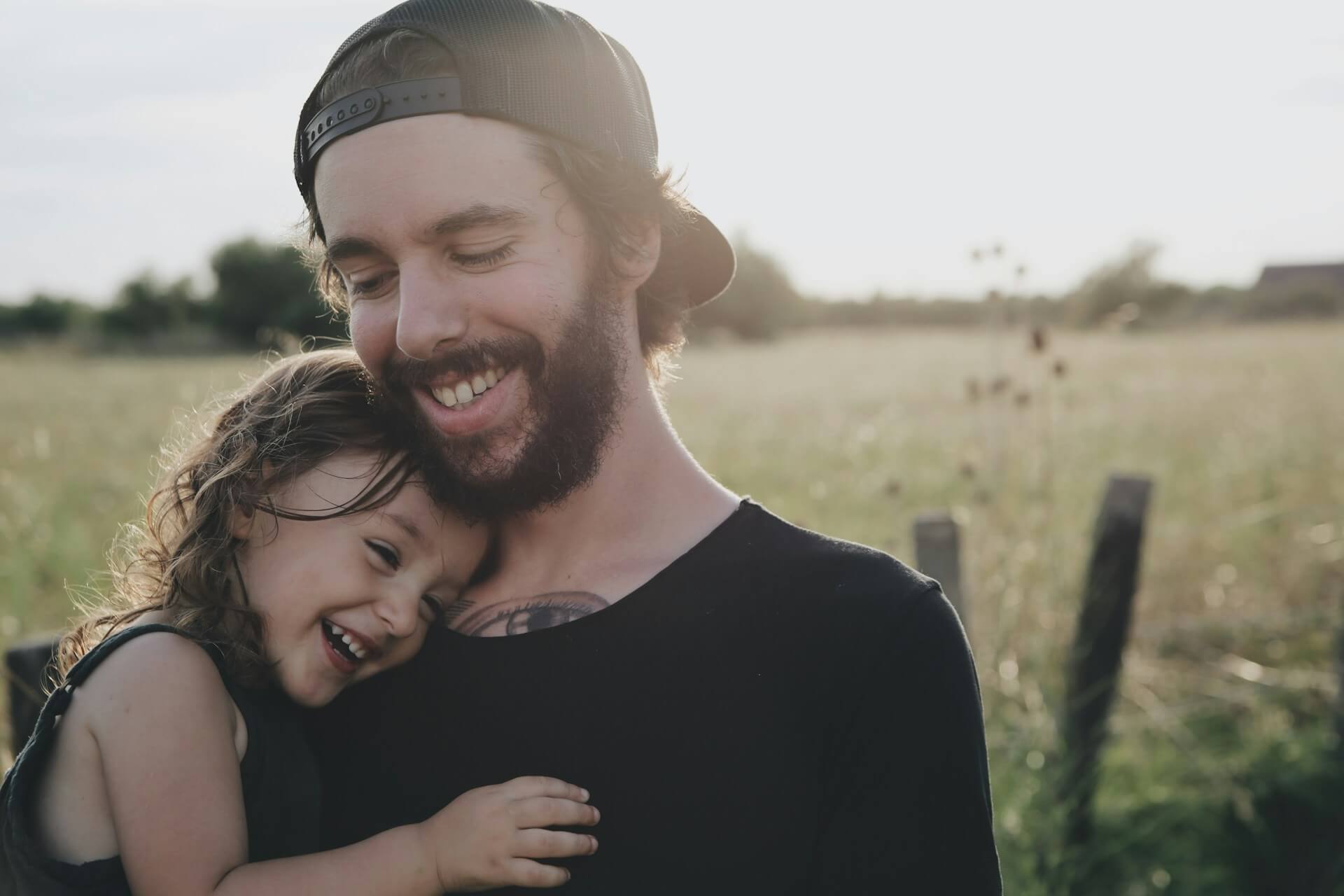 father holding his daughter outside