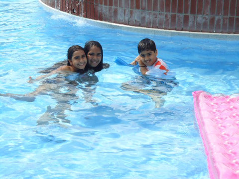 Kids playing in the pool.