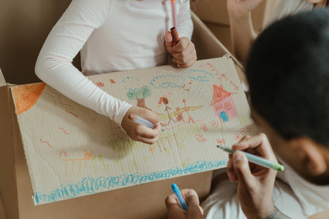 Another decorating a box with her daughter to use for pretend play, a great way to join your child in pretend play activities.