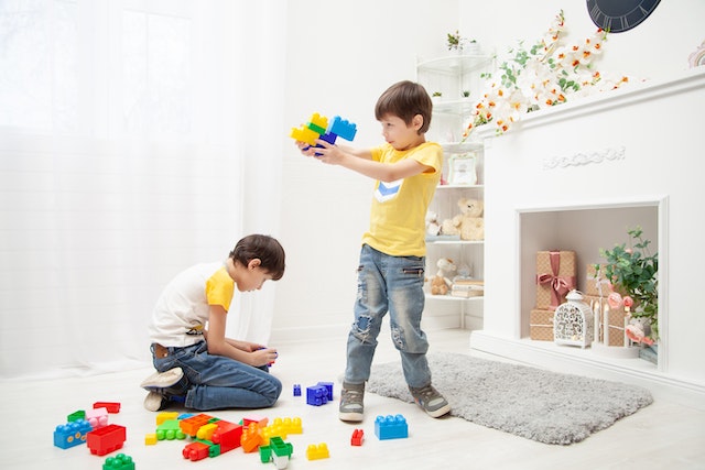 Two boys playing with blocks.