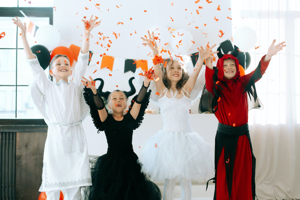 Kids in Halloween costumes portraying how to host the best dress-up party for kids.