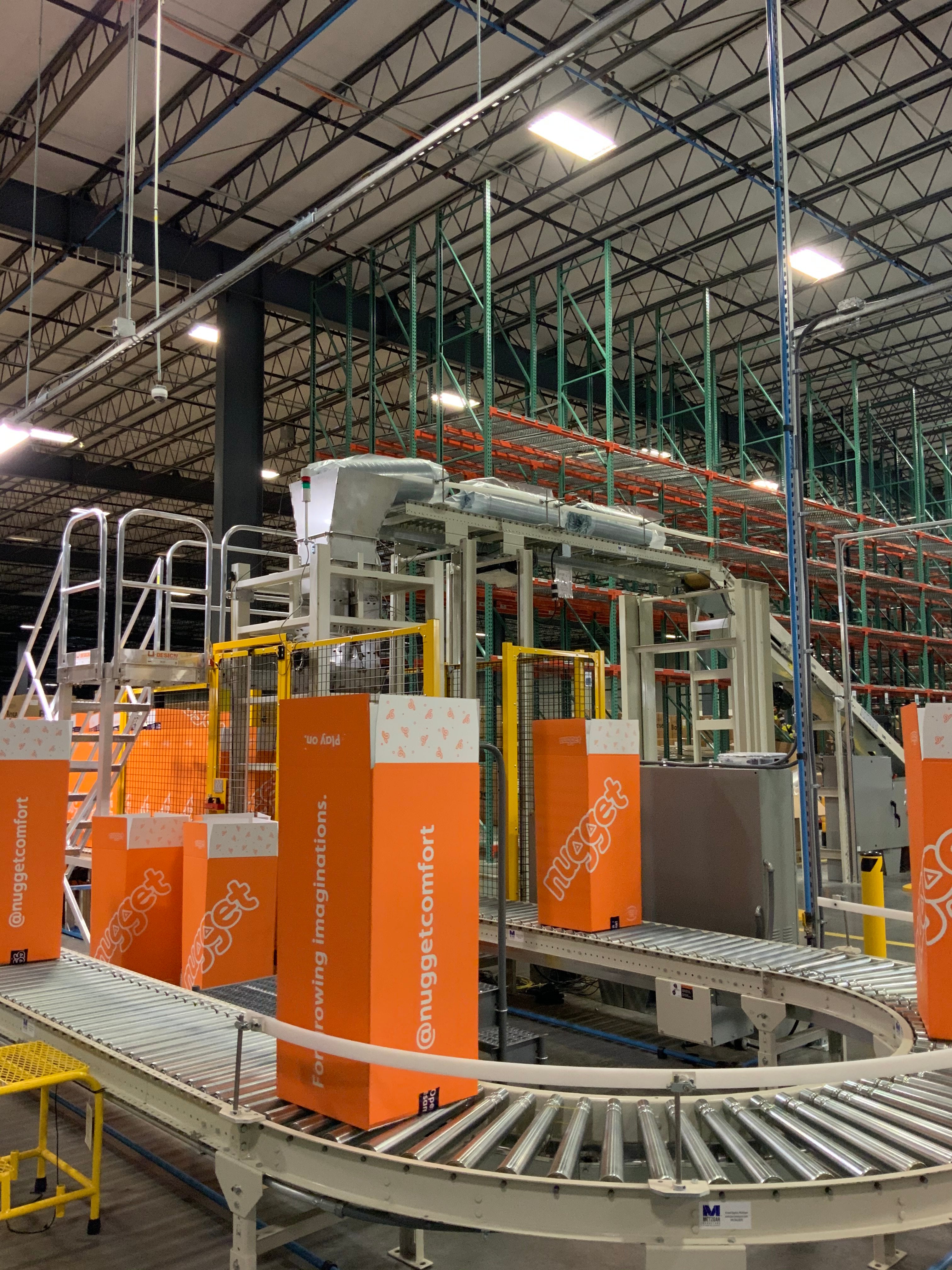 Conveyer belt with multiple Big Orange Boxes and burrito dropper in background