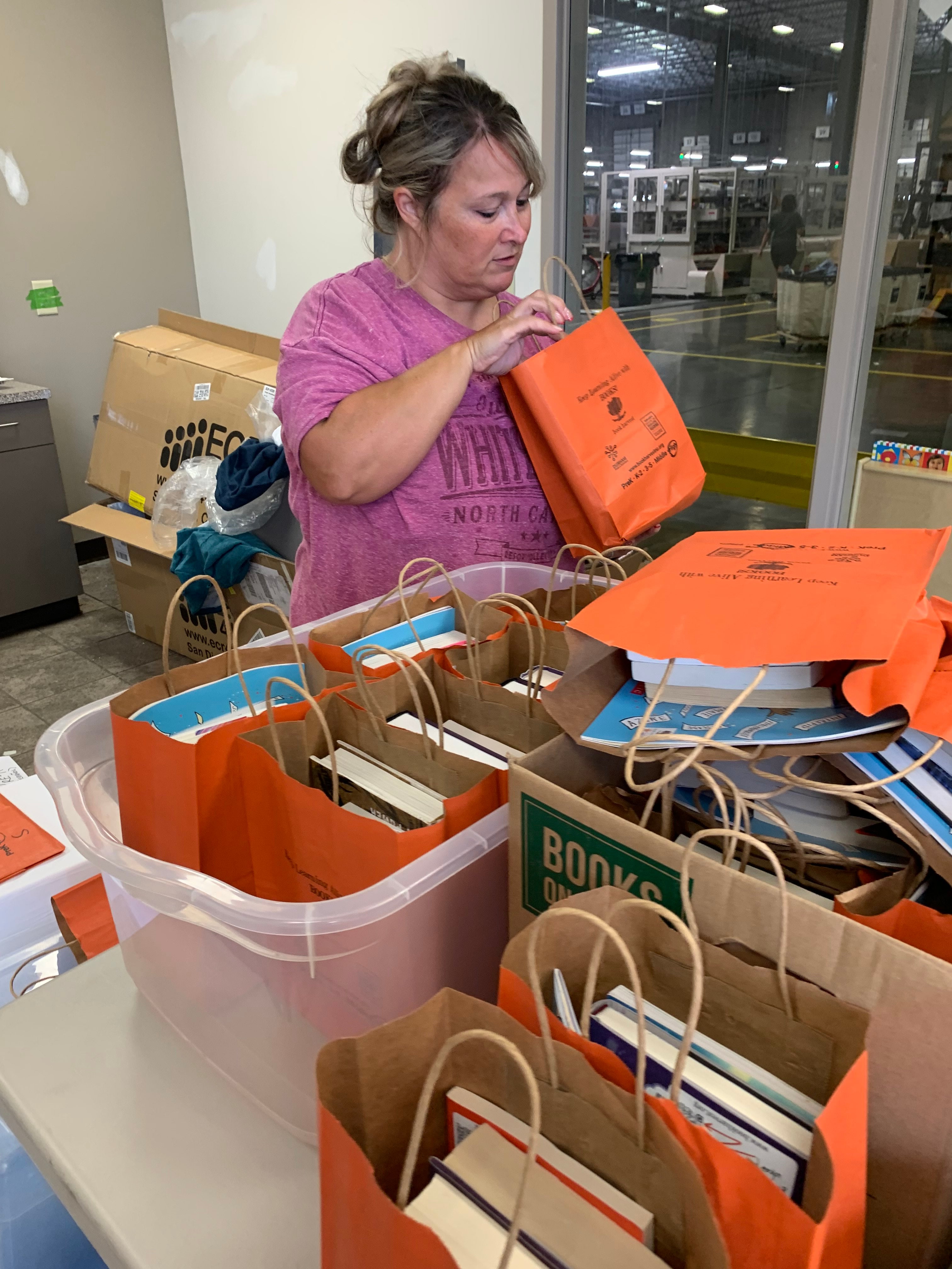 Nugget team member sorting through donation bags from Book Harvest