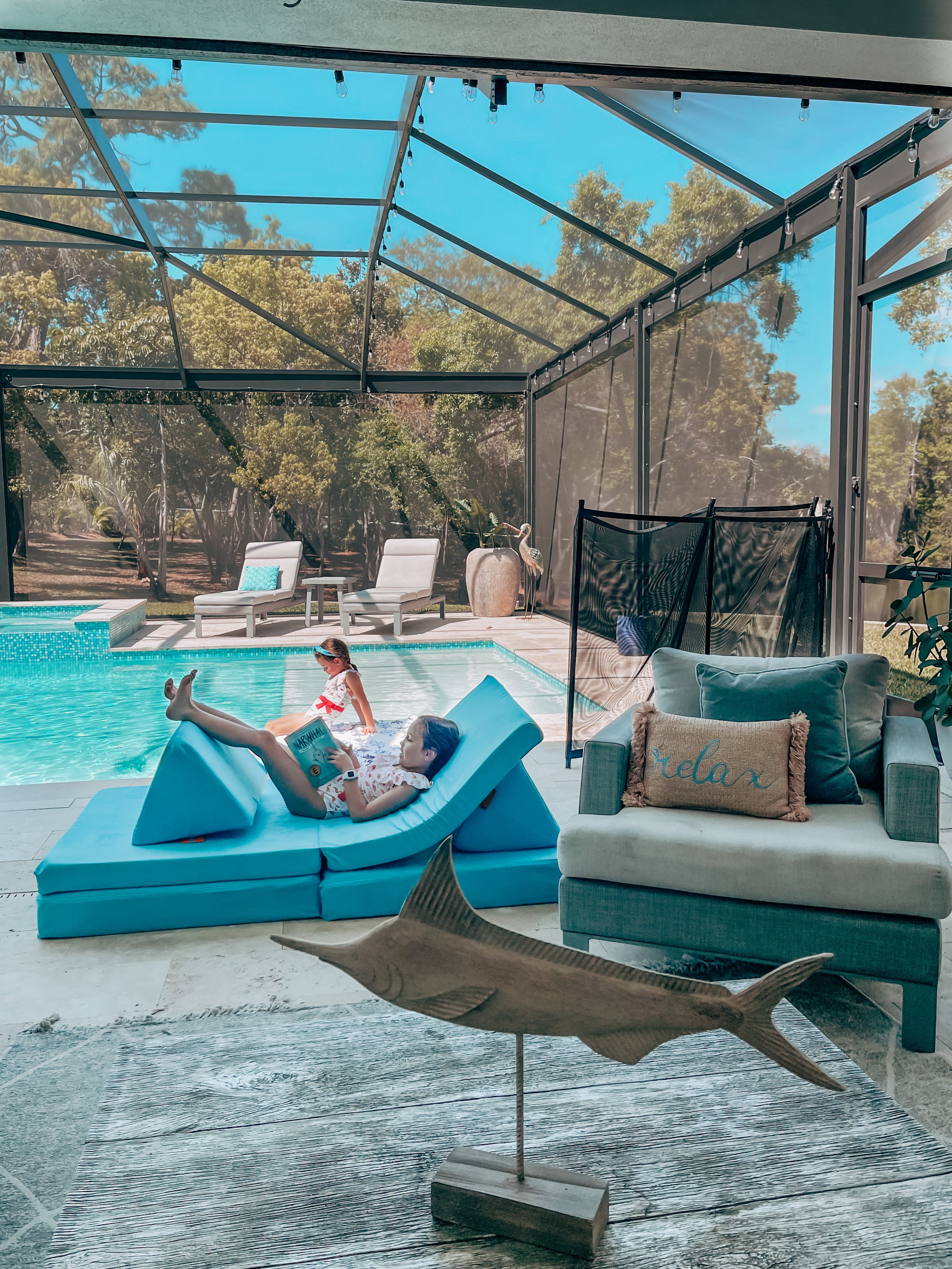 Snorkel-colored Nugget in a covered, outdoor living area that includes a beautiful pool.