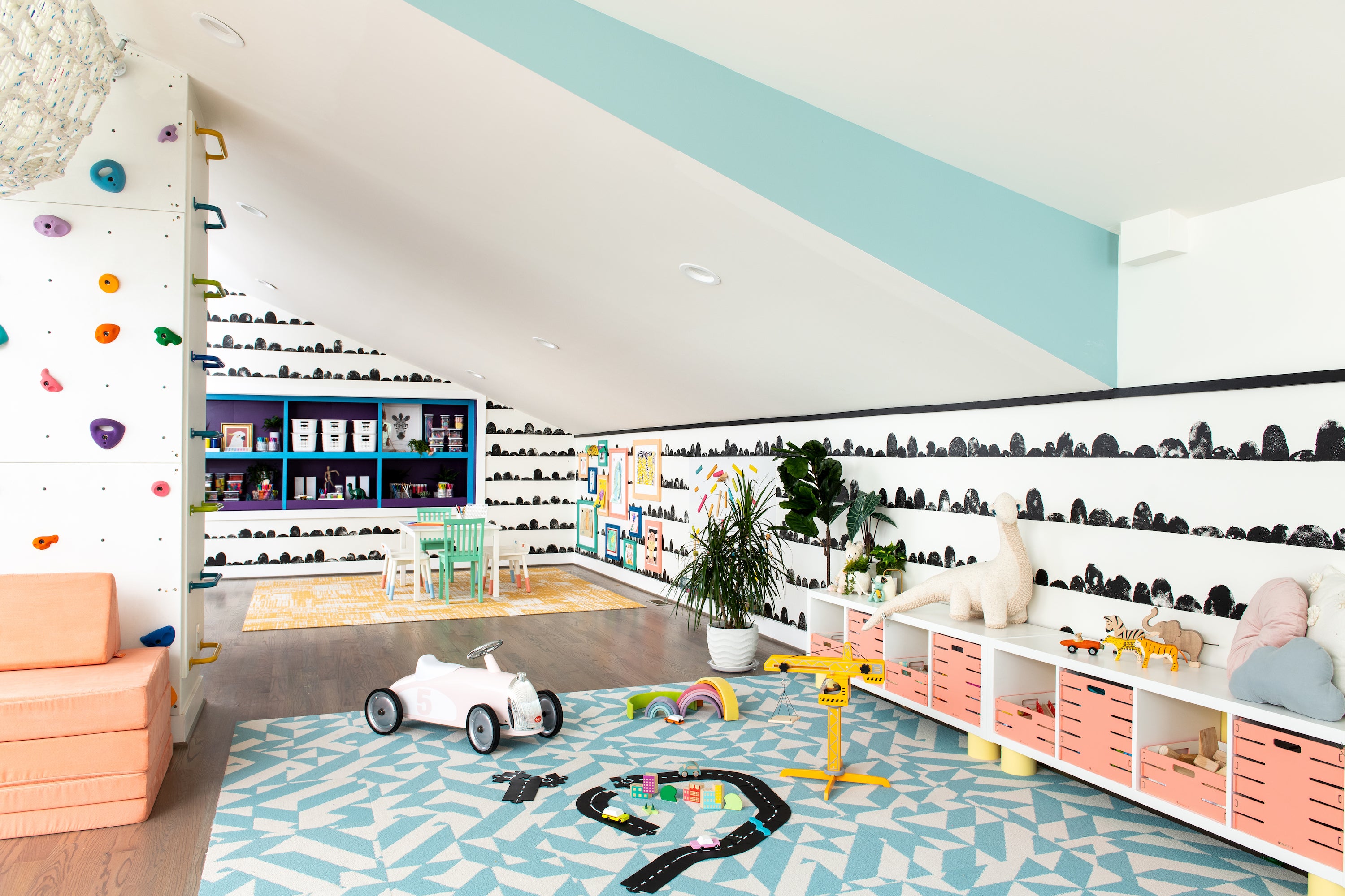 A grOH! designed playroom with low, accessible toy storage, open floor space, and brightly colored walls and floors.