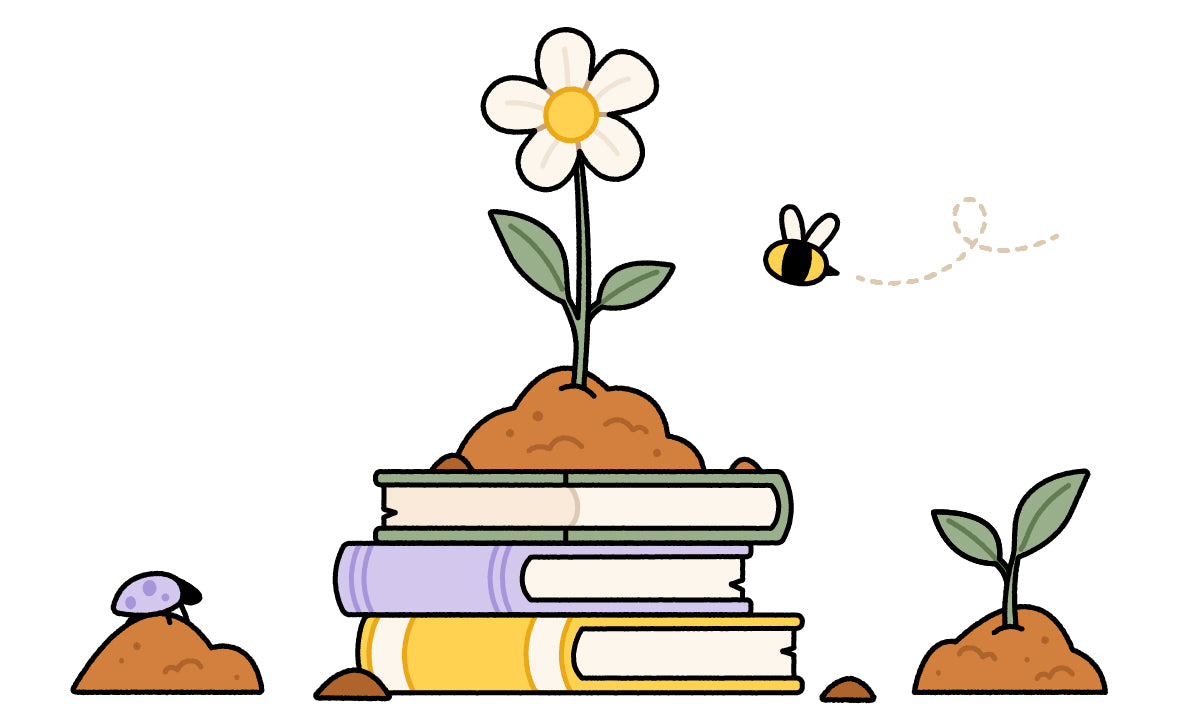 Books stacked with dirt on top with a flower growing out of the top
