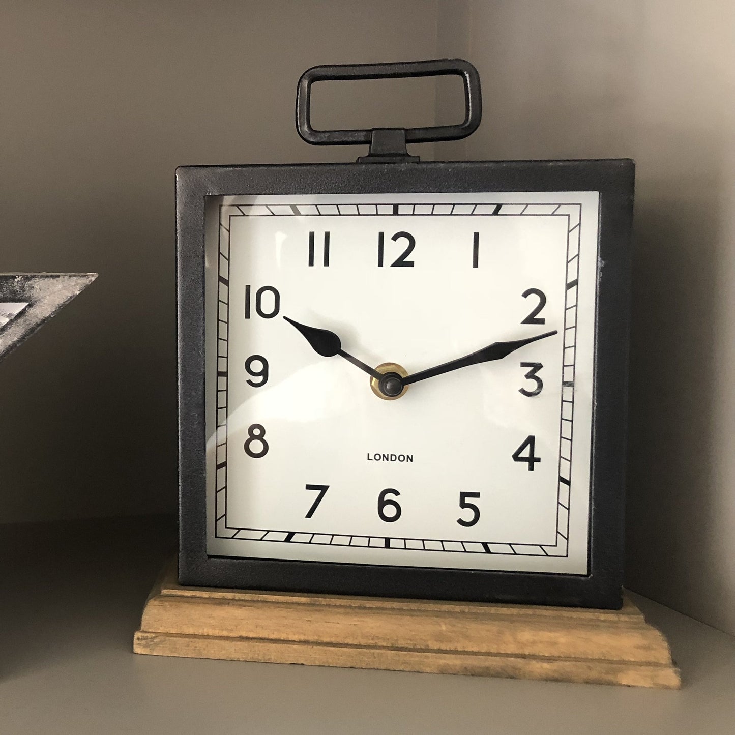 Vintage metal clock with wooden base, perfect for adding a classic touch to any home!  Size is 22cm x 18cm 