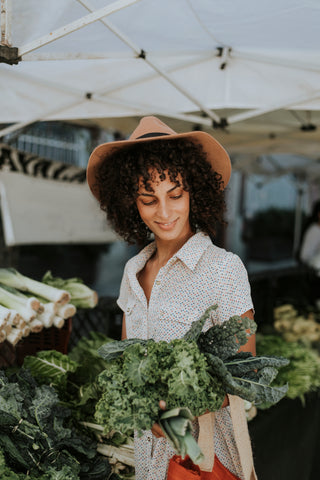 Beautiful woman holding green veggies