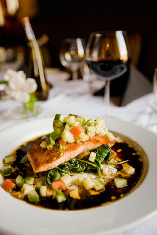 Salmon dish with vegetables and red wine