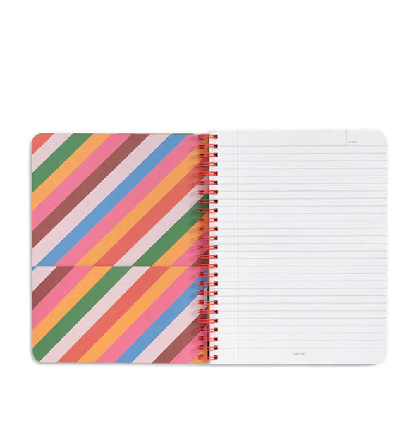 Open notebook with red spiral-bound lined page and decorative striped pocket page